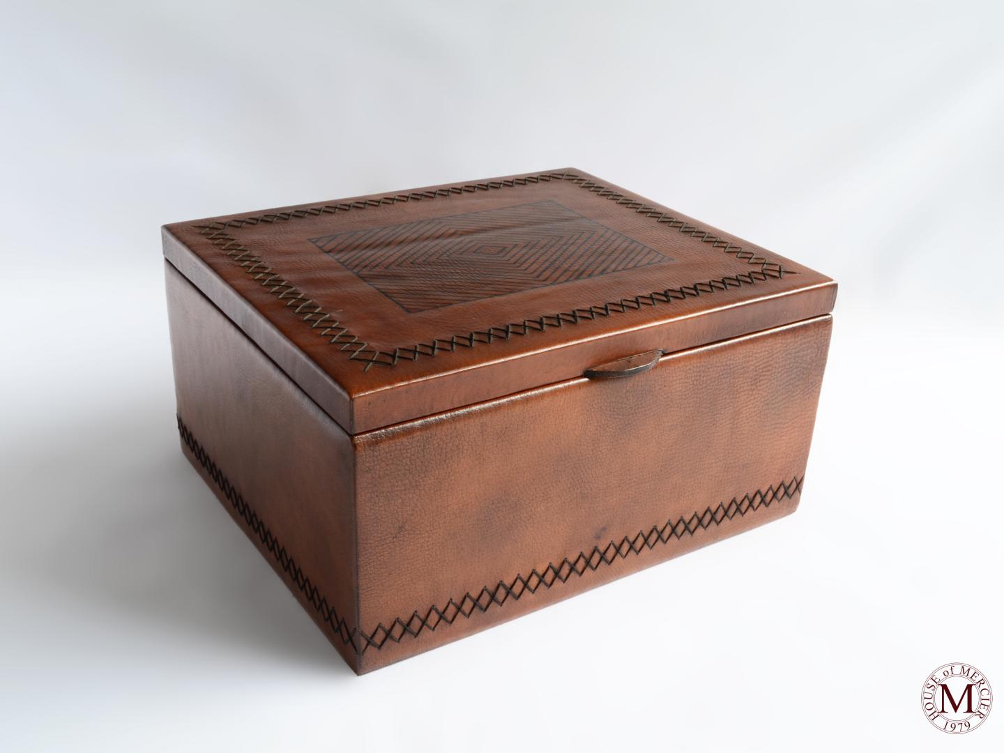leather box with a sewed around the box and a tribal design on top